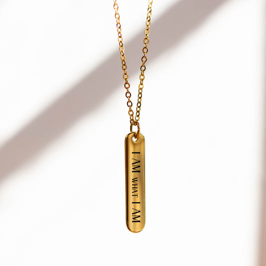 Gold necklace with a pendant on a white background